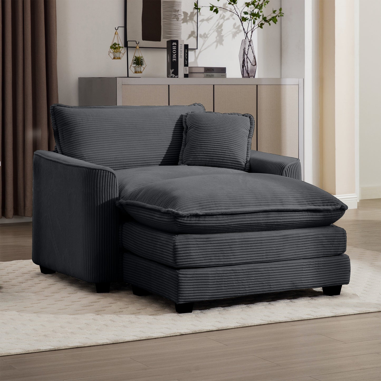 Comfortable dark gray corduroy chaise lounge with plush cushions and an included throw pillow for relaxation