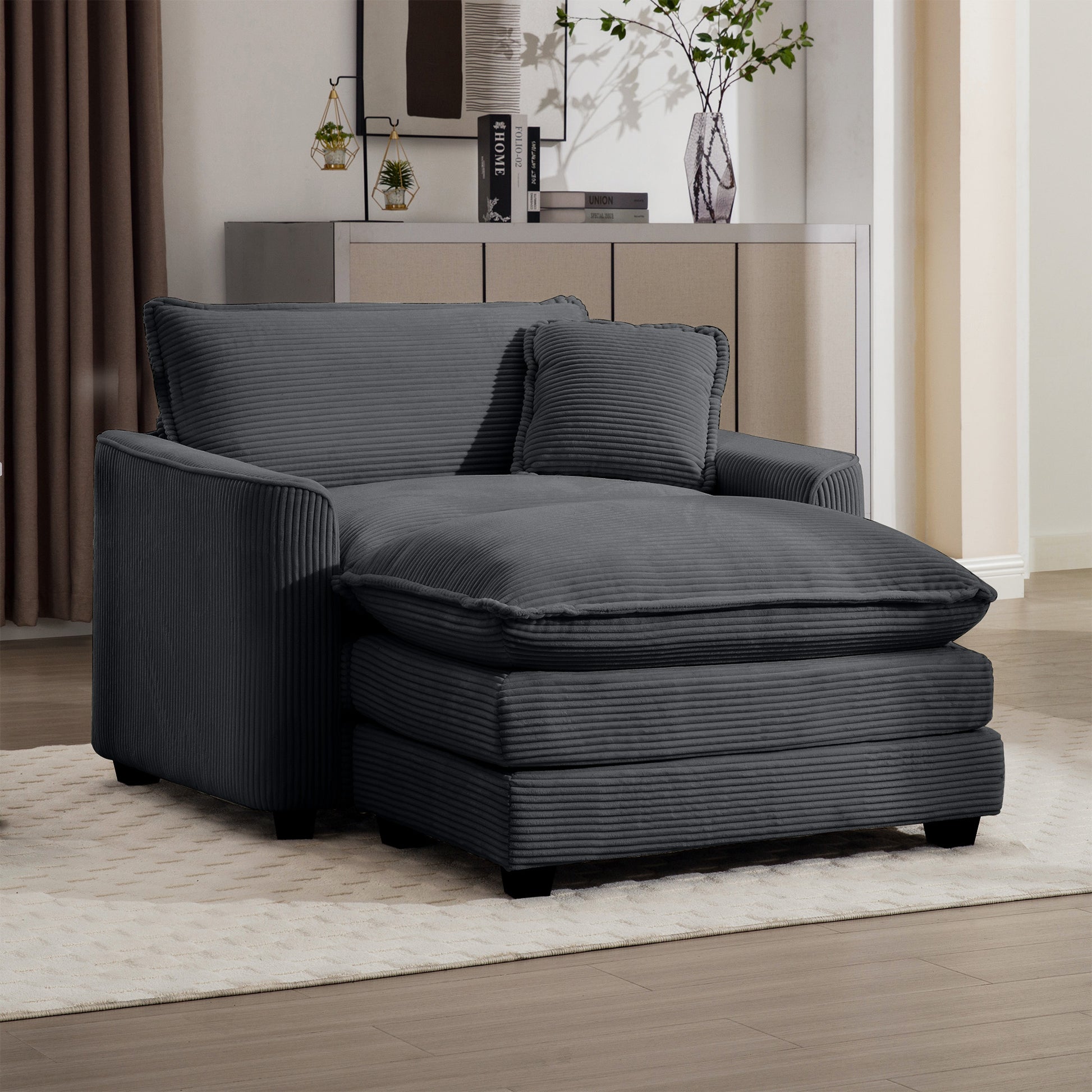 Comfortable dark gray corduroy chaise lounge with plush cushions and an included throw pillow for relaxation