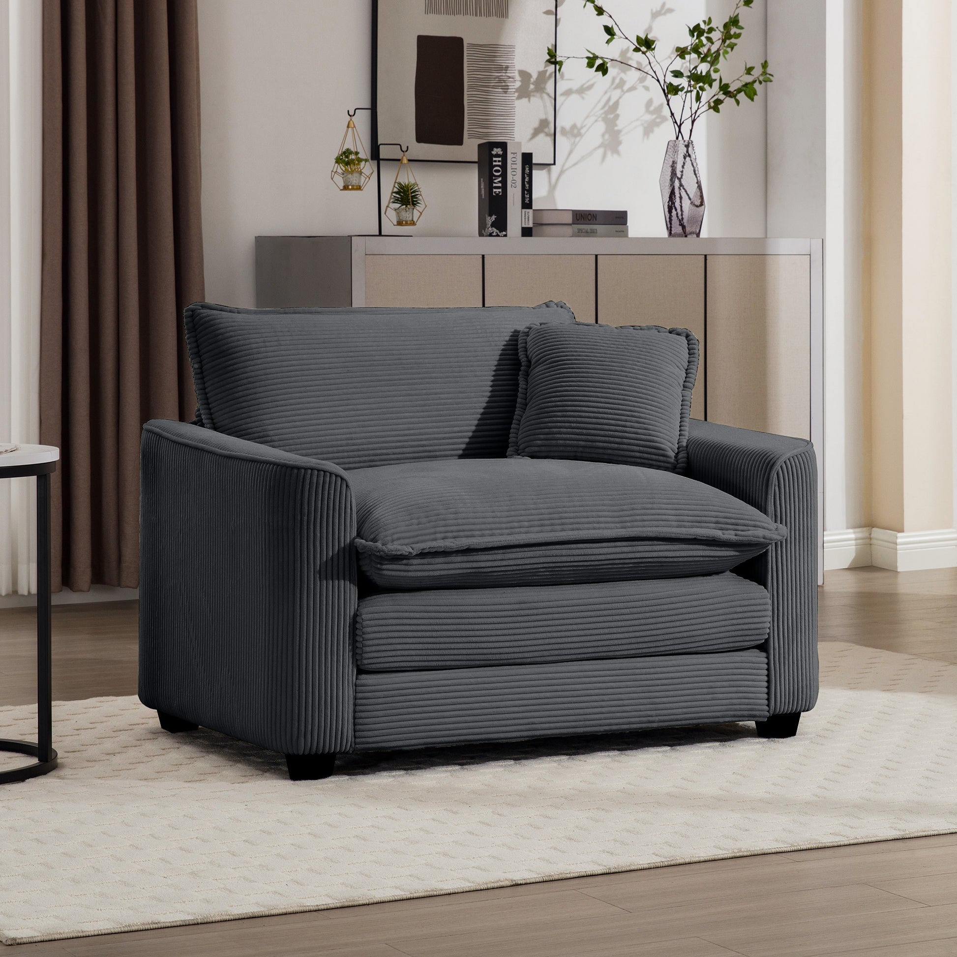 Cozy charcoal corduroy accent chair with plush cushions and a matching throw pillow