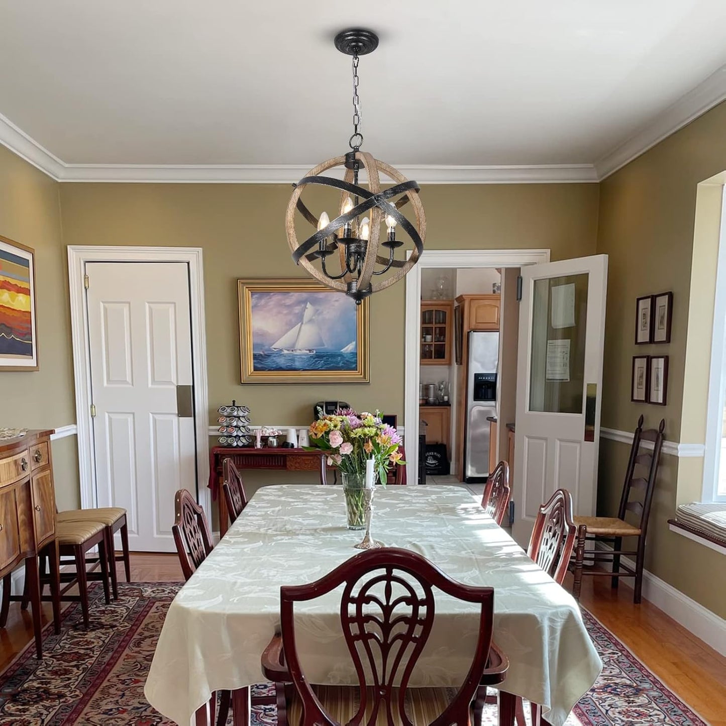 Orb chandelier with rustic wood and metal finish hangs over a formal dining table