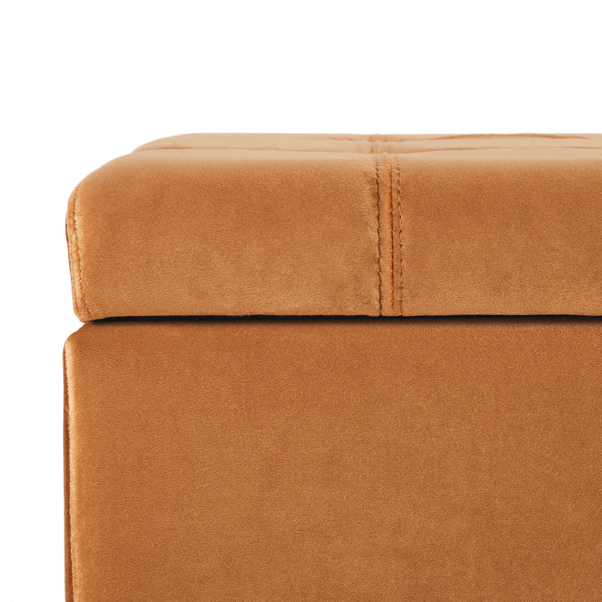 Upholstered storage ottoman in rich caramel velvet with deep tufting detail
