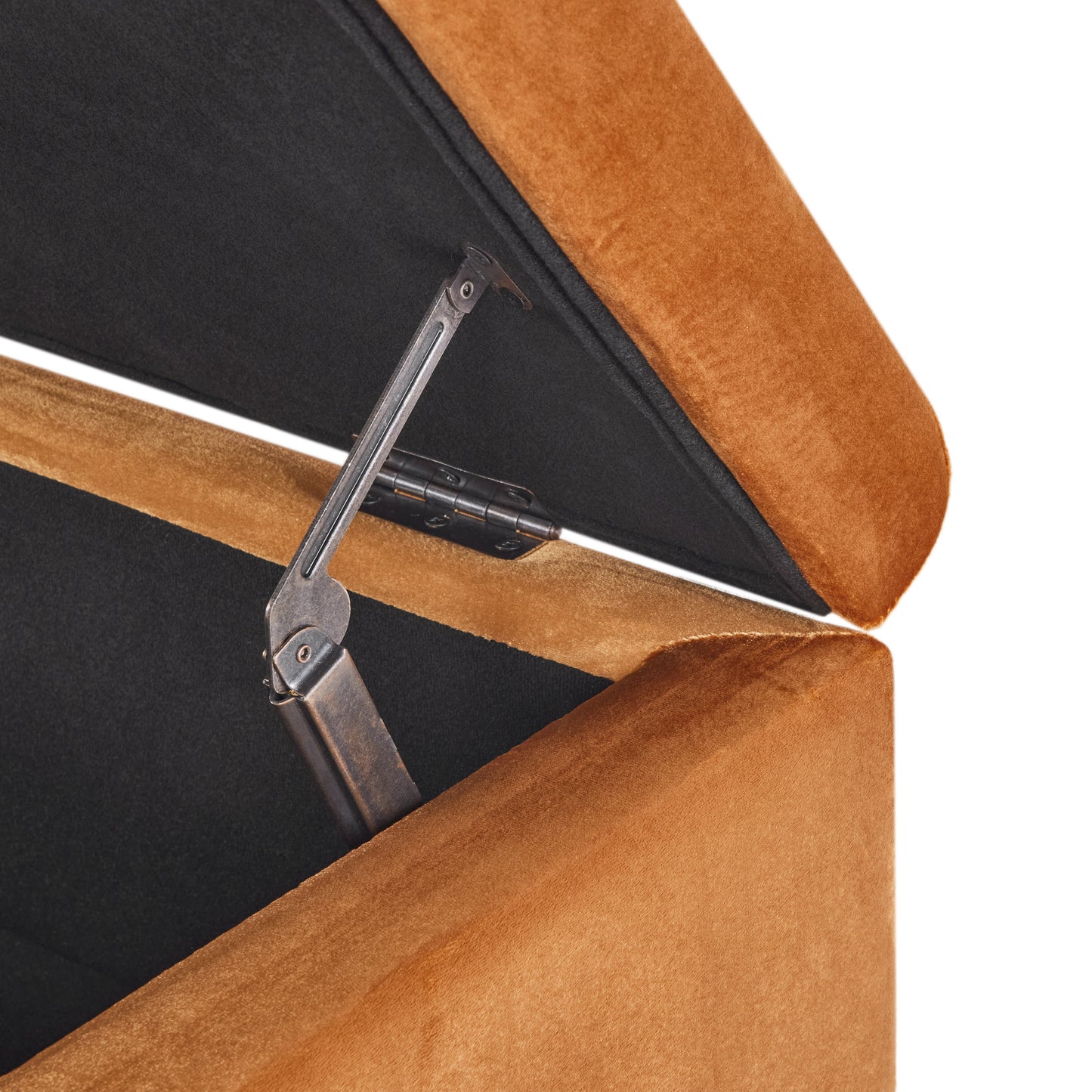 Orange velvet ottoman lid with visible metal hinge and dark interior lining