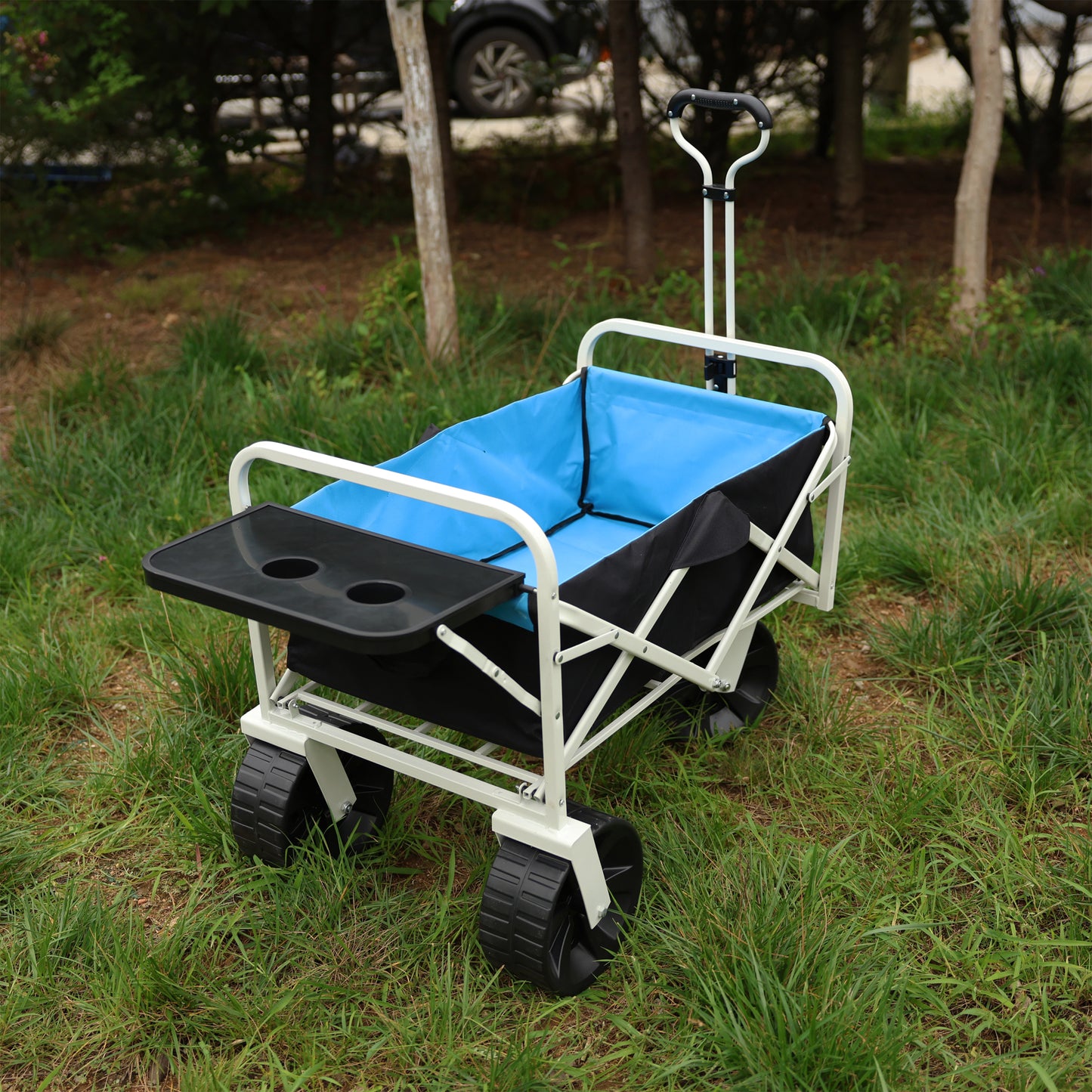 Blue fabric collapsible utility wagon with a black serving tray and cup holders