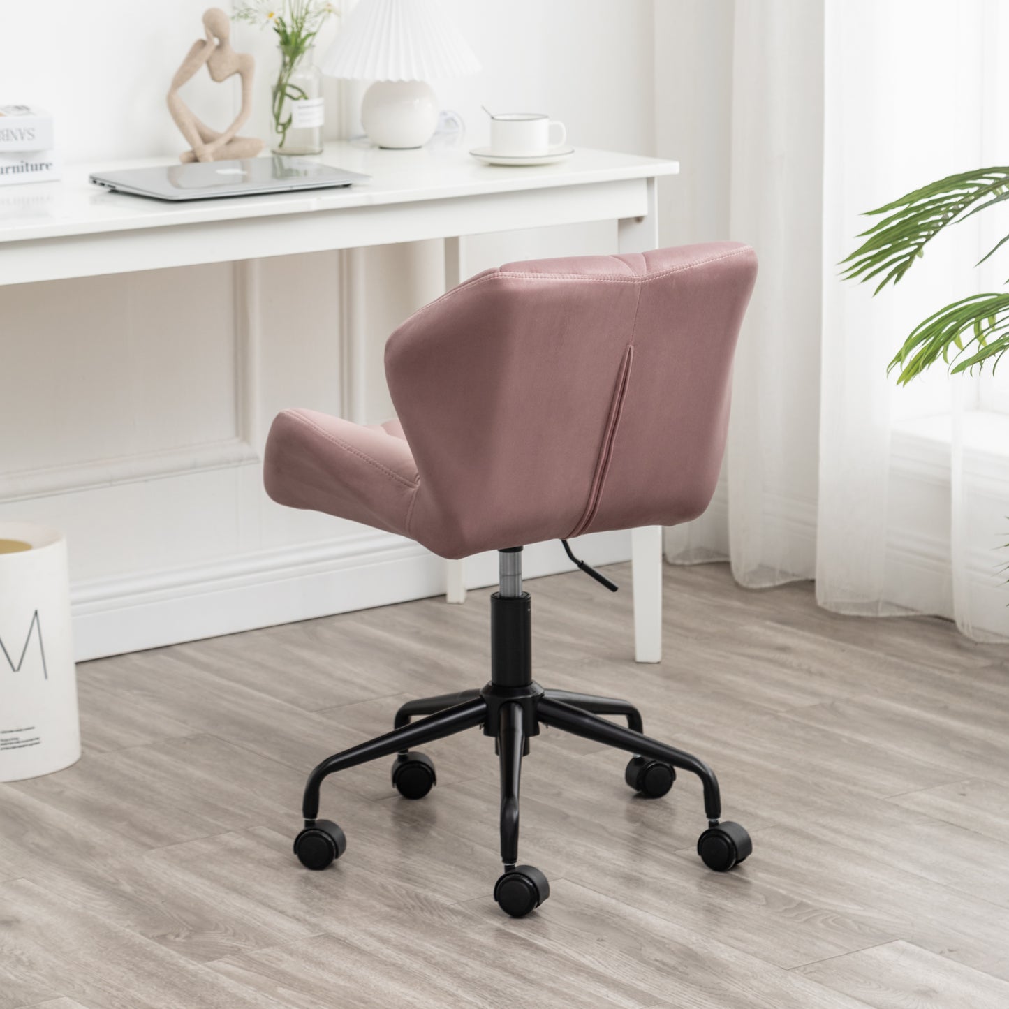 Dusty rose velvet executive chair with black metal base and casters for home office