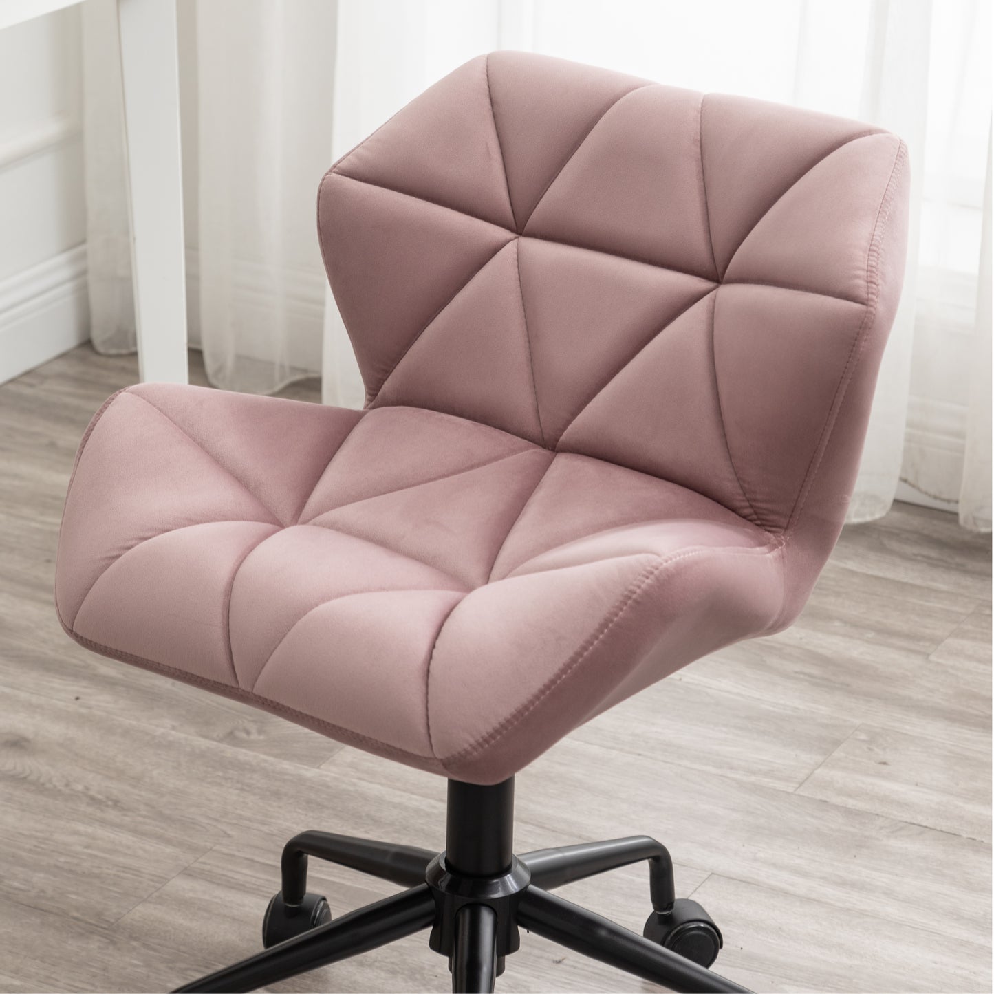 Pink velvet office chair with diamond tufting and a black base