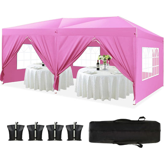 Pink event canopy tent with windows and draped sides set up over whiteclothed tables