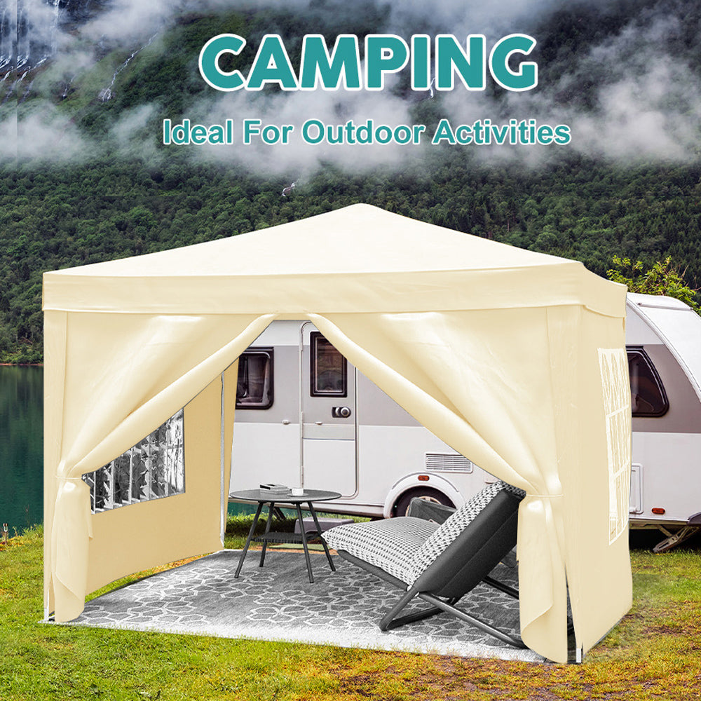 Cream colored pop up canopy tent set up next to an RV for outdoor activities