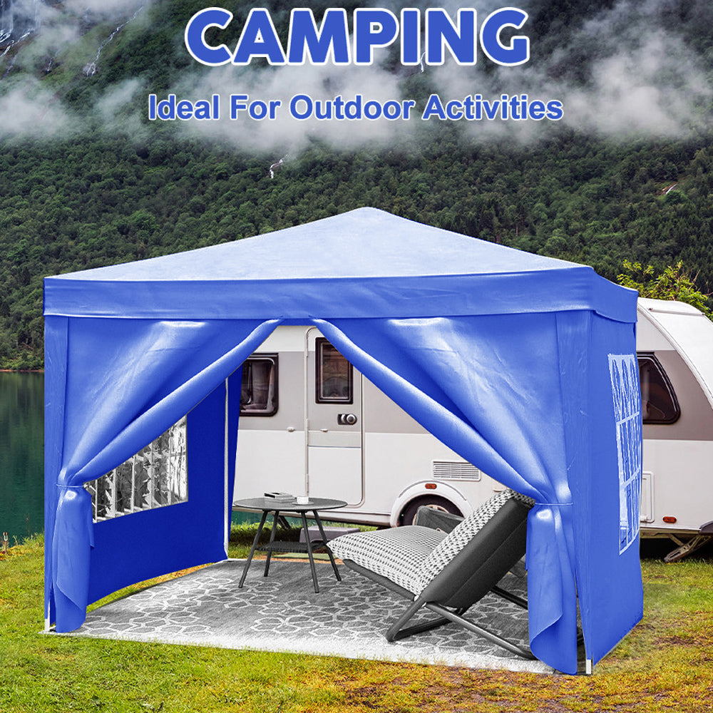 Blue popup canopy tent set up beside a caravan ideal for camping and outdoor events
