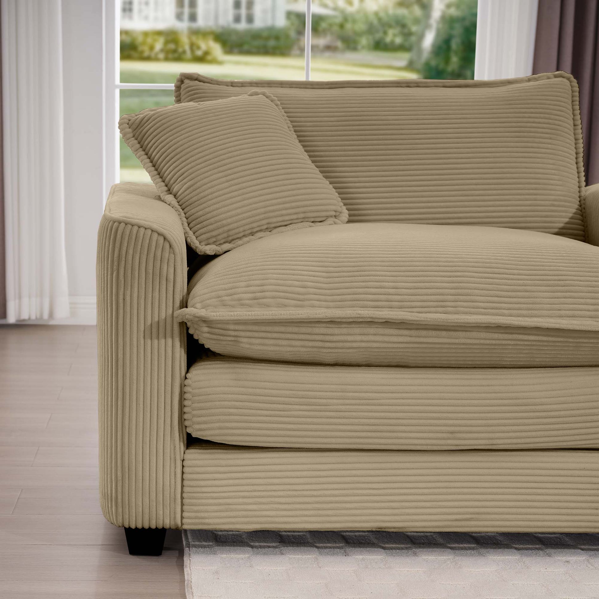 Beige corduroy sofa with plush cushions and a decorative pillow