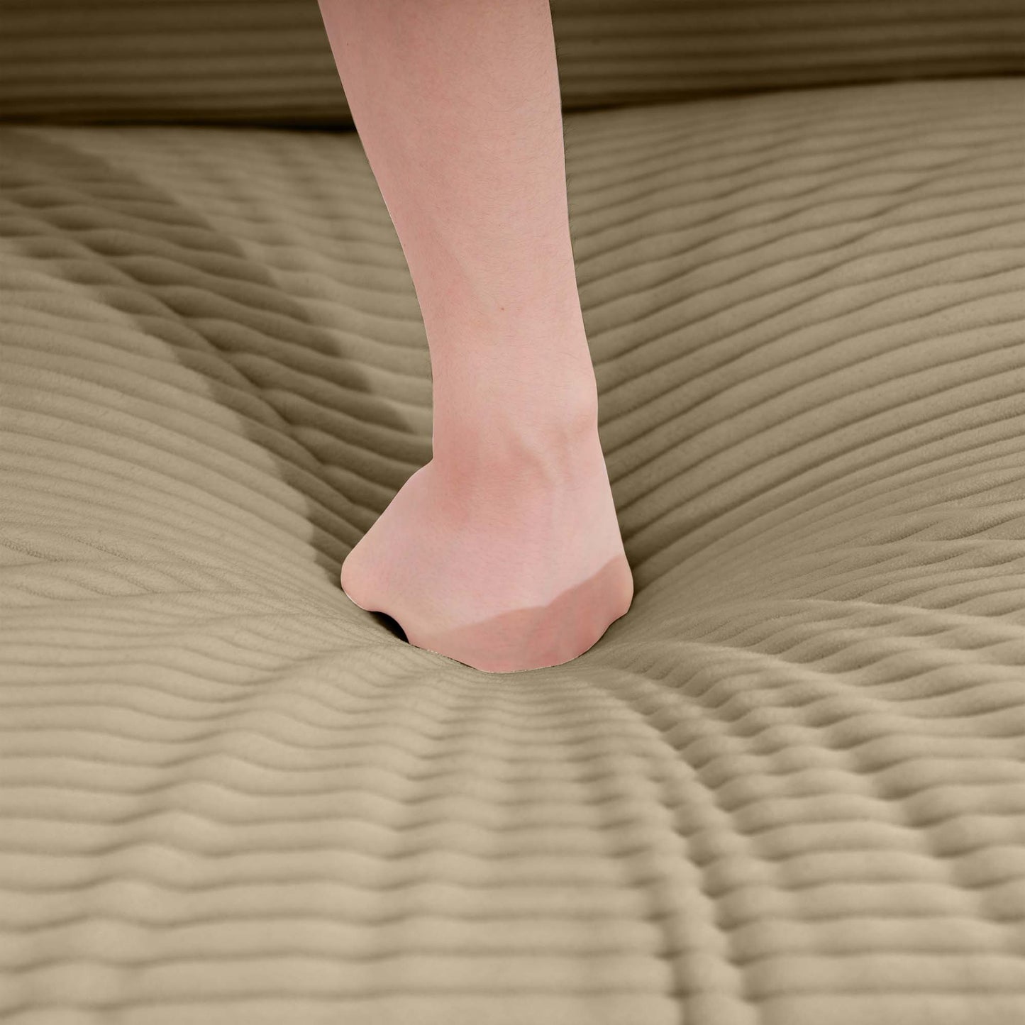 Beige corduroy sofa texture with a foot pressing into it showcasing comfort