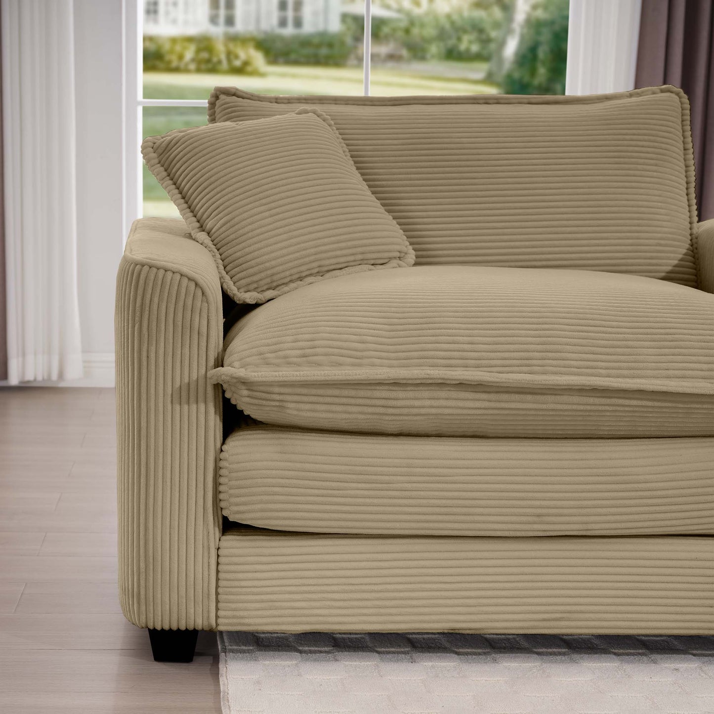 Beige corduroy sofa with plush cushions and a decorative throw pillow