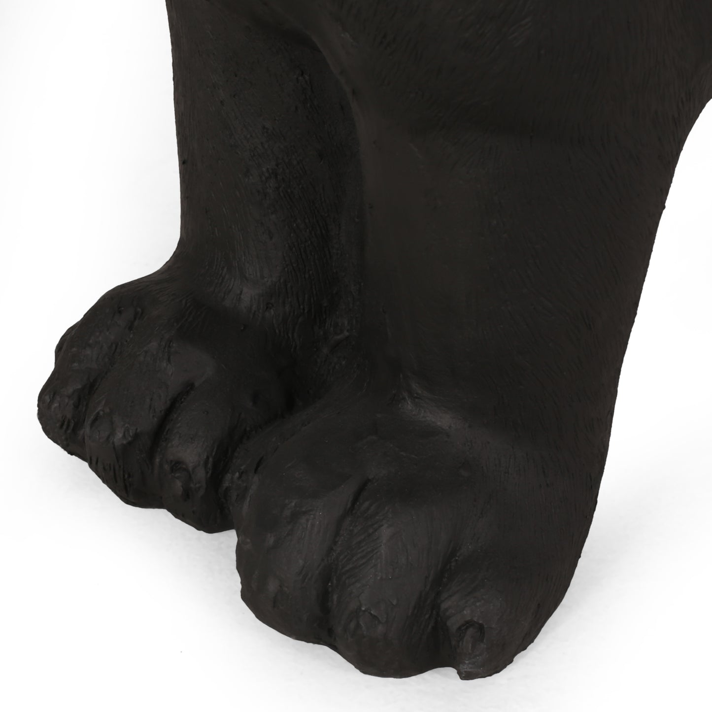 Closeup of textured black bear paws artistic statue detail