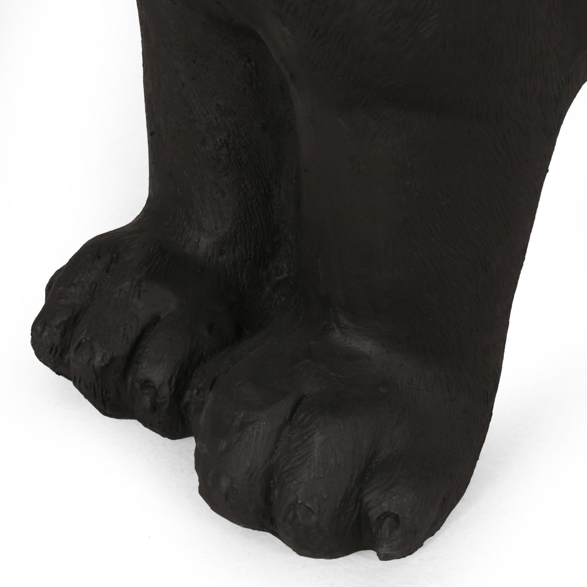 Closeup of textured black bear paws artistic statue detail
