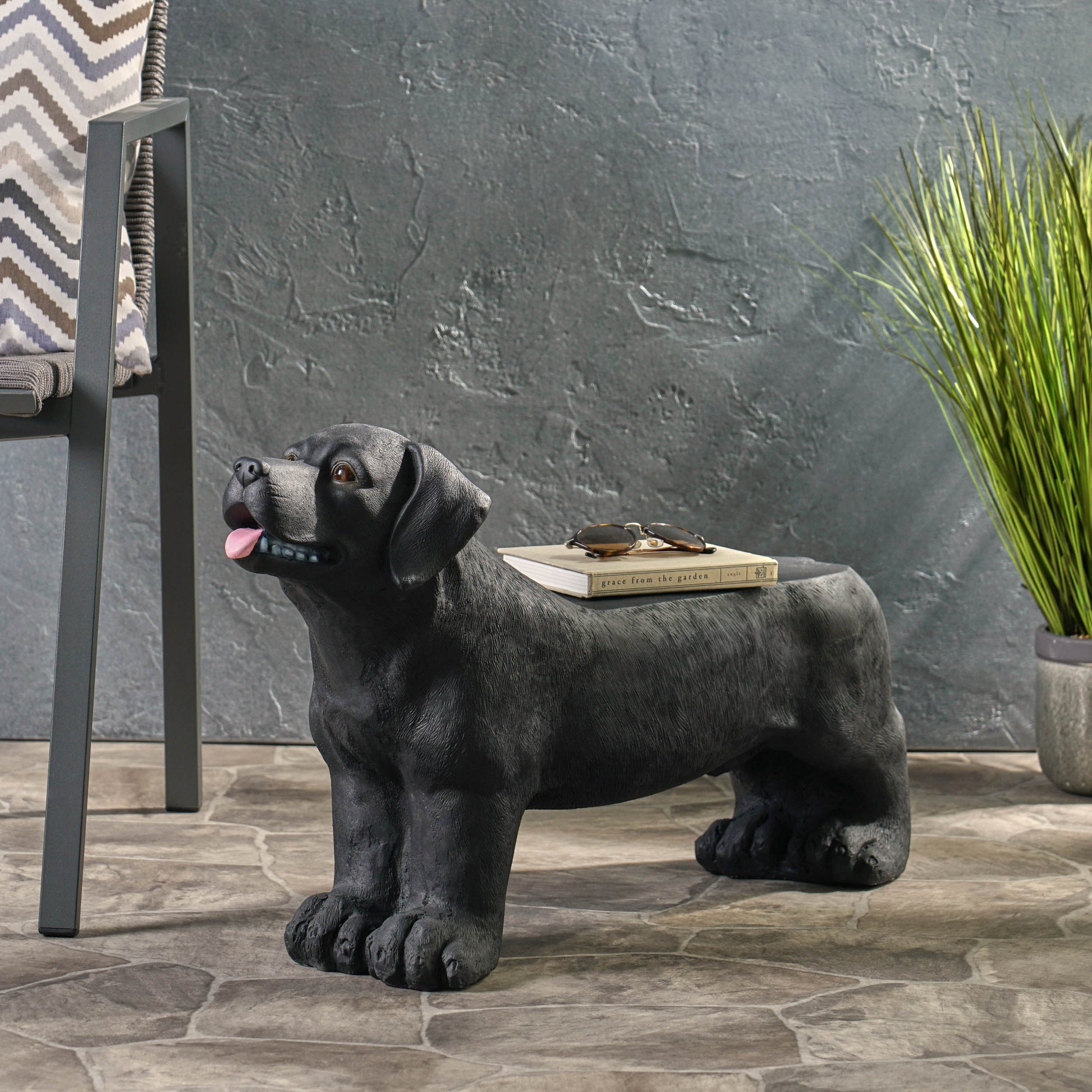 Black Labrador dog statue side table with realistic fur texture and book detail