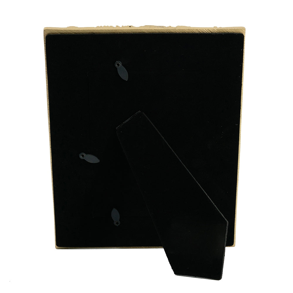 Back of a gold ornate photo frame with black velvet backing and easel