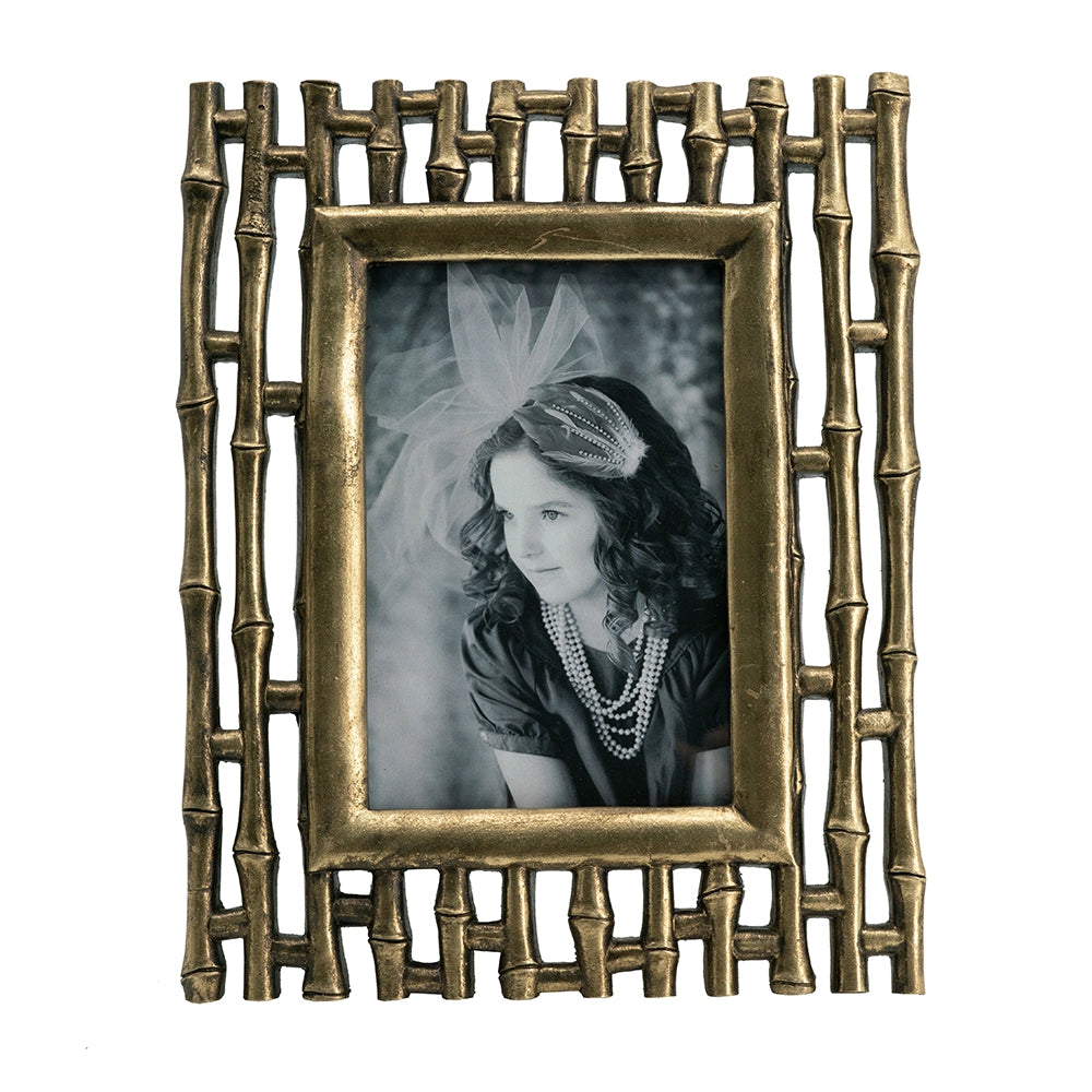 Antique brass bamboostyle photo frame holding a vintage black and white portrait