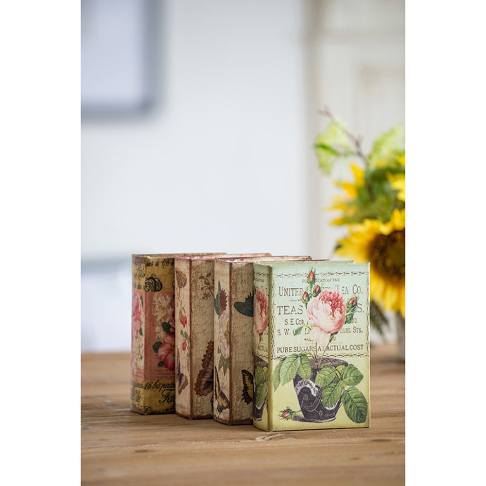 Four decorative book boxes with floral and butterfly vintage print designs