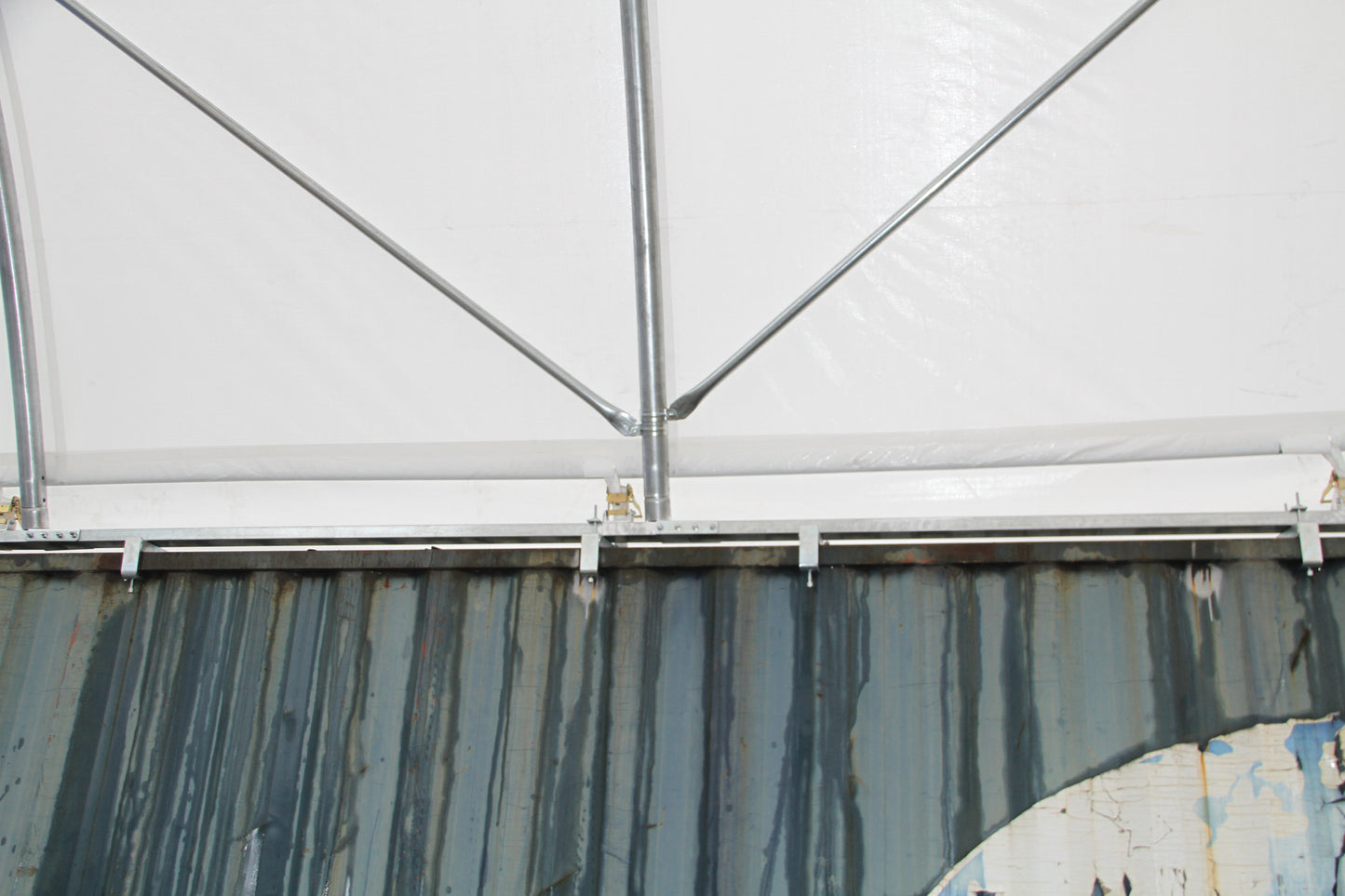Corrugated metal shipping container side with streaks of rust and wear