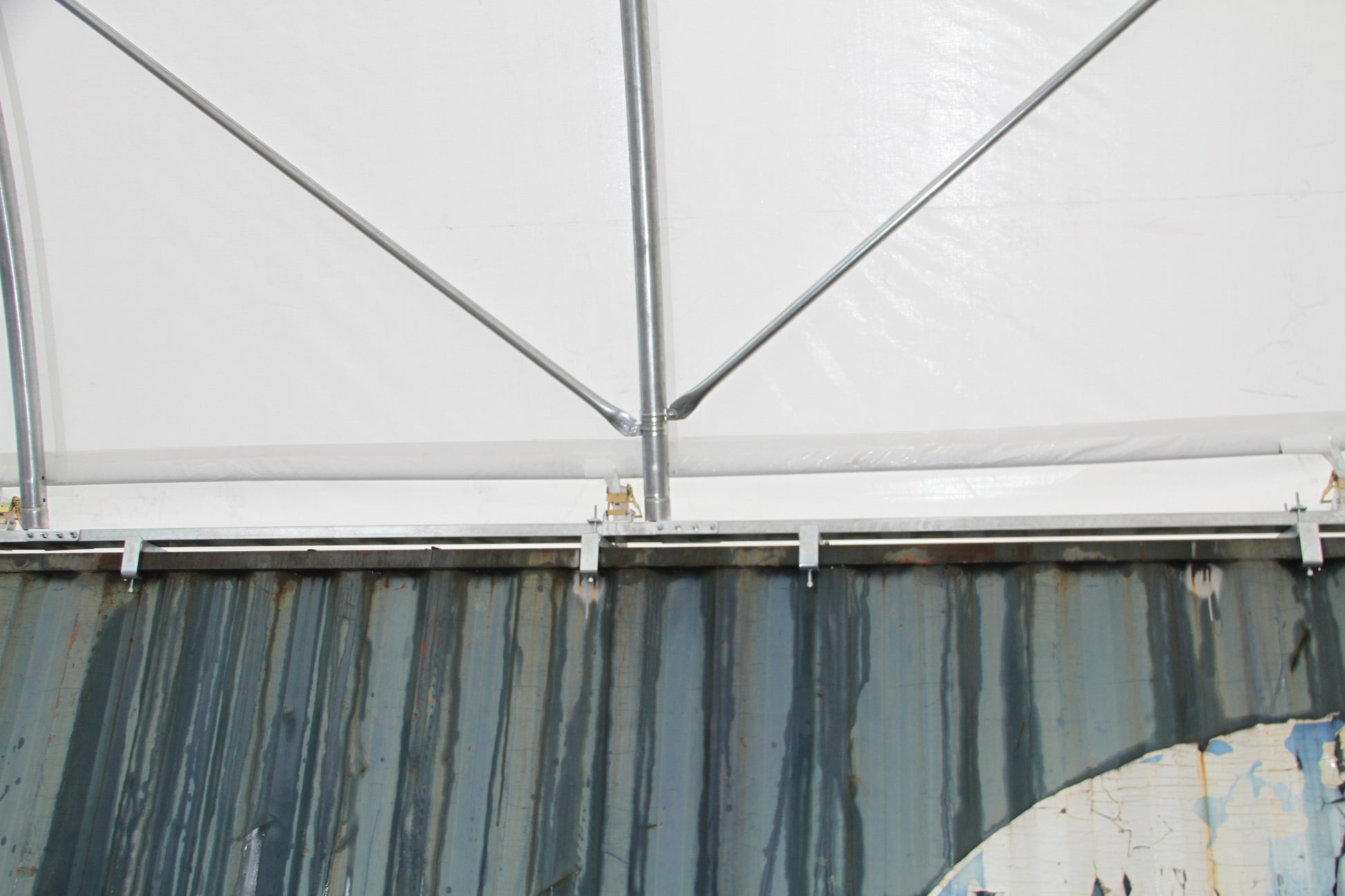 Corrugated metal shipping container side with streaks of rust and wear