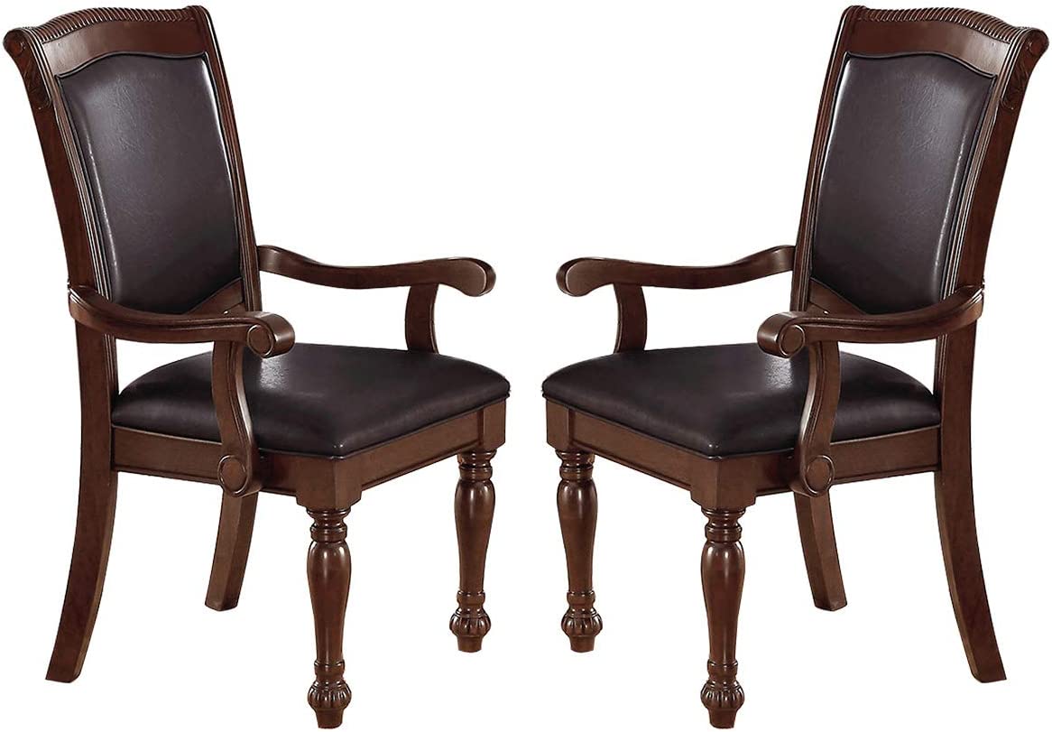 Two ornate dark brown wood dining chairs with padded faux leather seats and armrests classic style