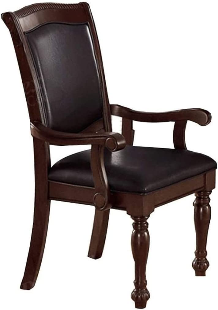 Dark brown leather upholstered arm chair with carved wood accents and turned legs