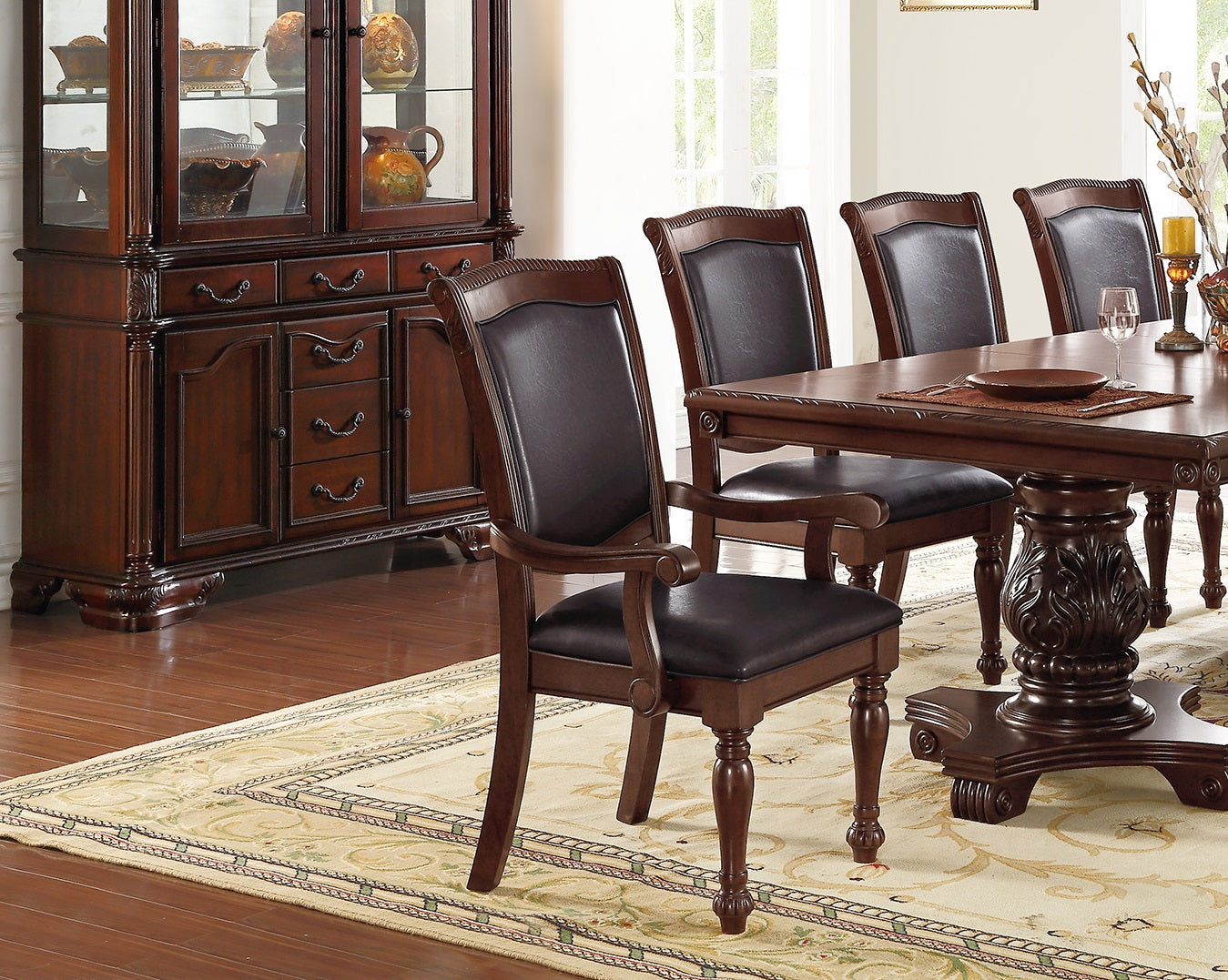 Dark brown leather upholstered arm chair with carved wooden legs for dining room