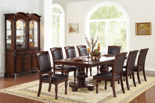 Ornate dark wood dining table with eight upholstered chairs for elegant entertaining