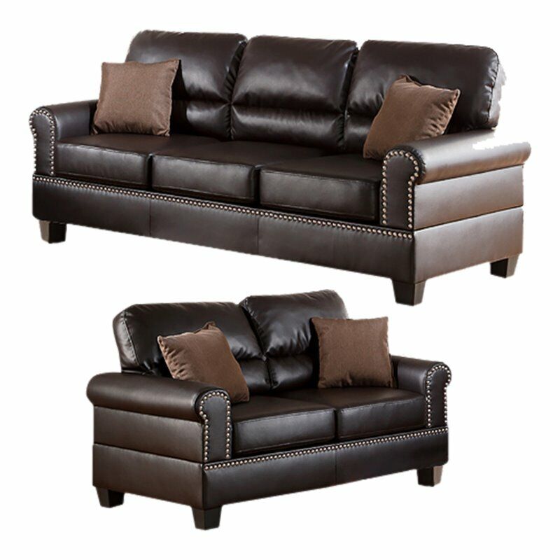 Dark brown faux leather sofa set with decorative nailhead trim and plush cushions
