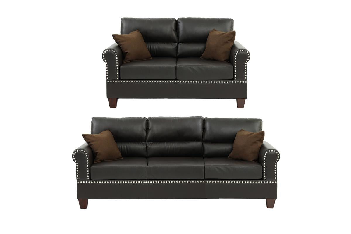 Dark brown faux leather loveseat with studded armrests and two brown throw pillows