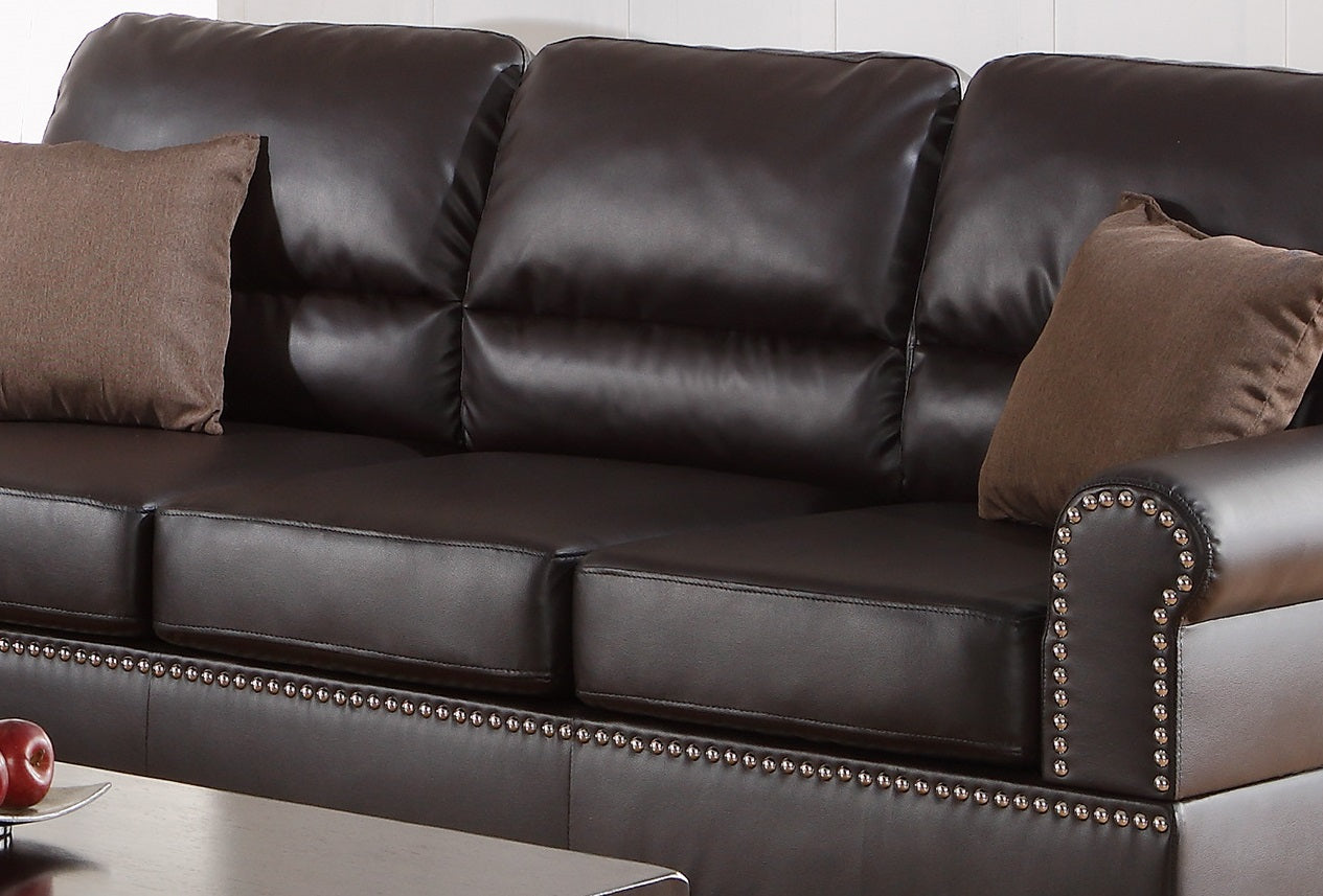 Dark brown leather sofa with plush cushions and decorative nailhead trim