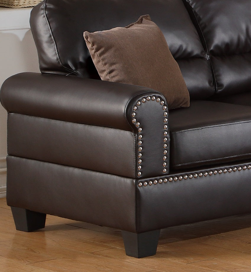 Dark brown faux leather sofa arm with decorative nailhead trim