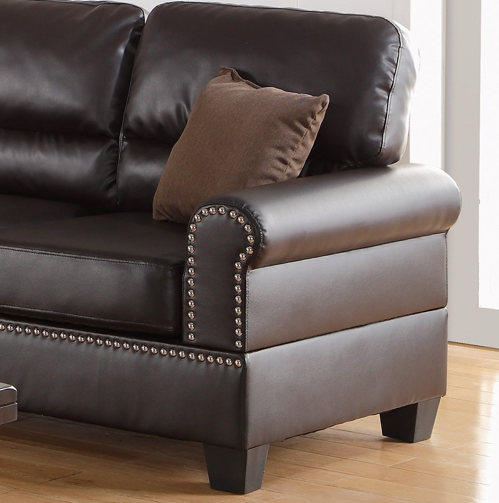 Dark brown leather sofa with studded armrest and brown throw pillow