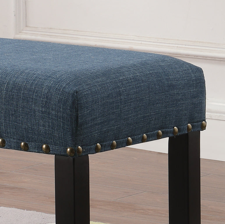 Blue fabric bench with brass nailhead trim and dark wood legs