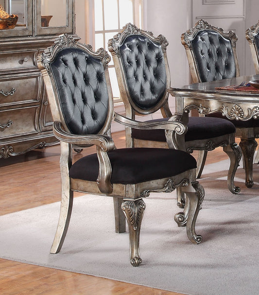 Tufted black leather upholstered dining chair with ornate silver antique finish wood frame