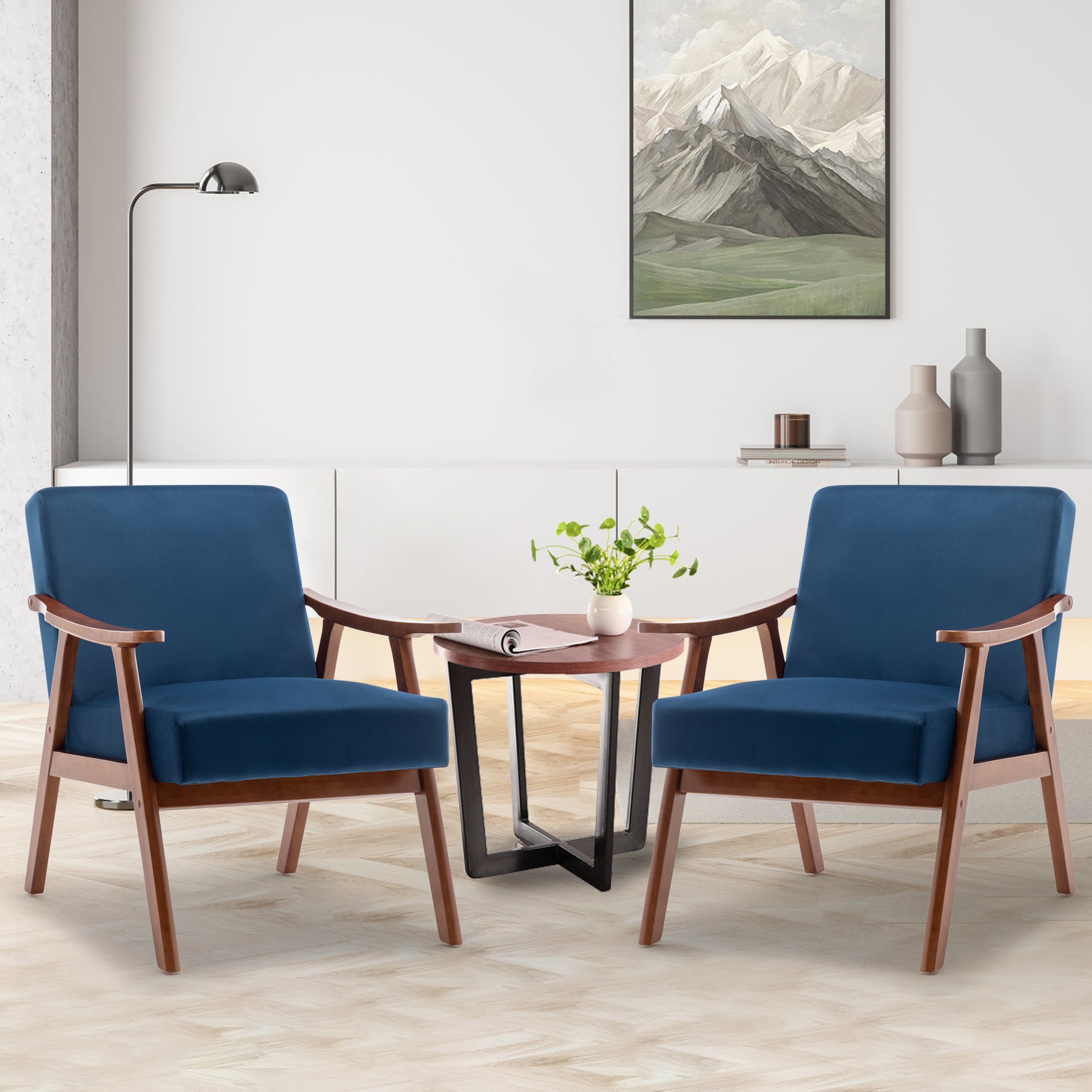 Two midcentury modern navy blue accent chairs with wooden frames and comfortable cushions