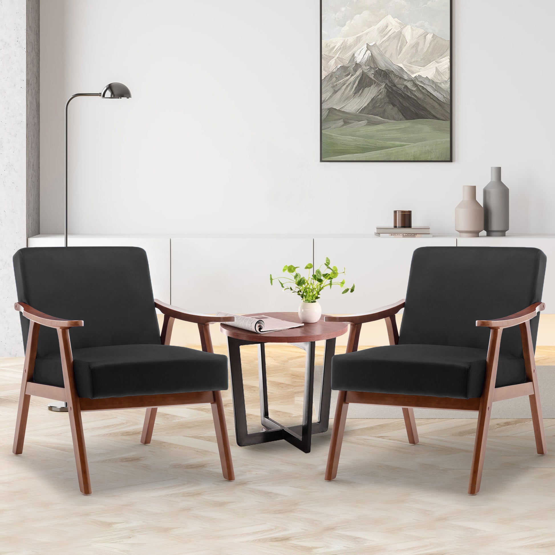 Two black accent chairs with wooden frames in a modern living room setting