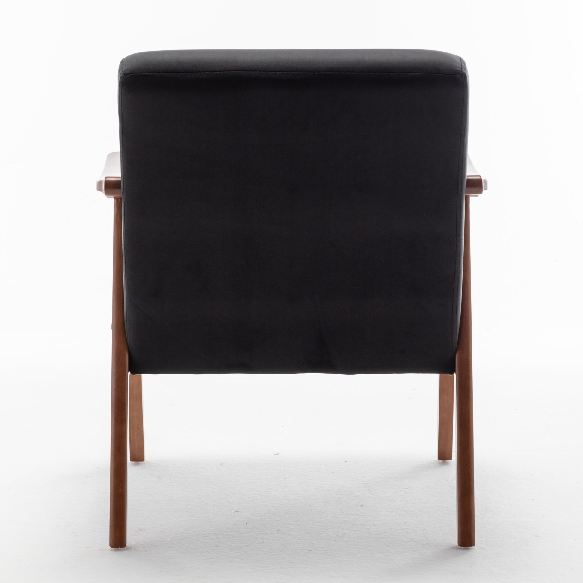 Back view of a black leather armchair with wooden legs modern accent chair