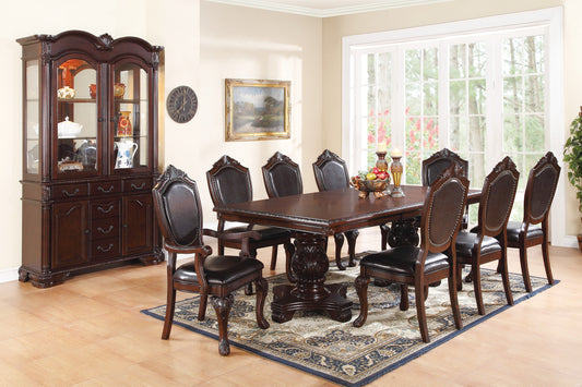 Ornate dark wood dining table with ornate upholstered chairs
