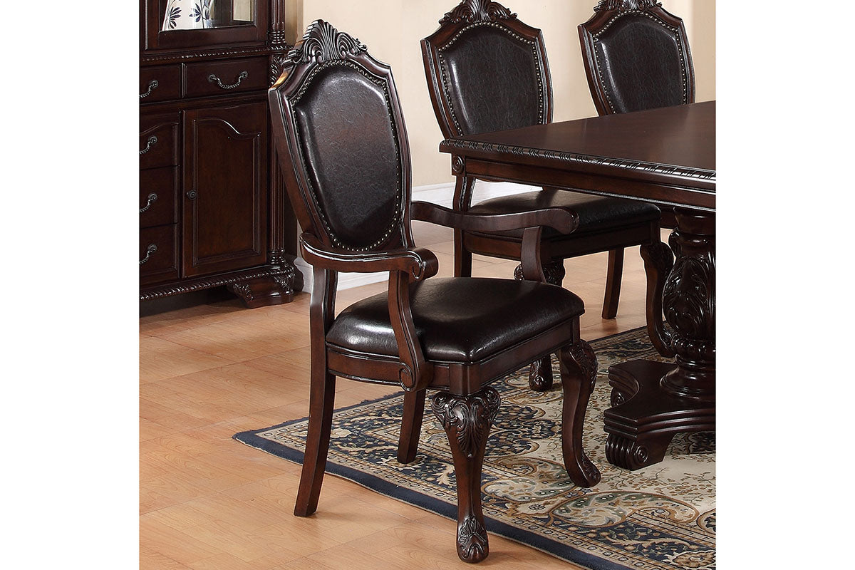 Dark brown leather upholstered dining chair with ornate carved wood frame and armrests