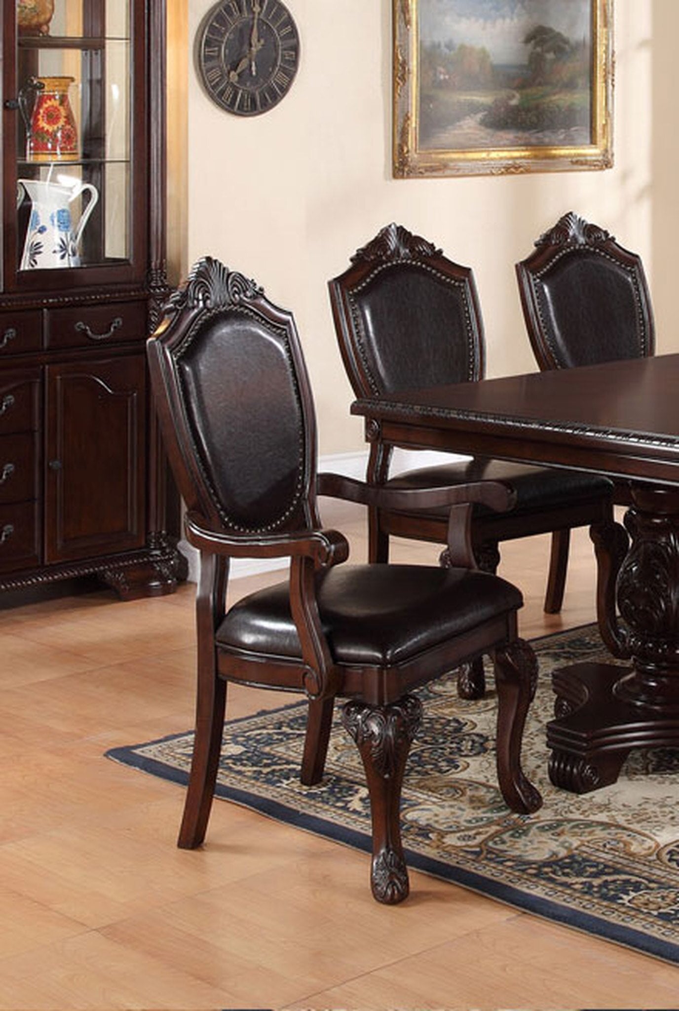 Dark brown leather upholstered dining chair with ornate dark wood frame