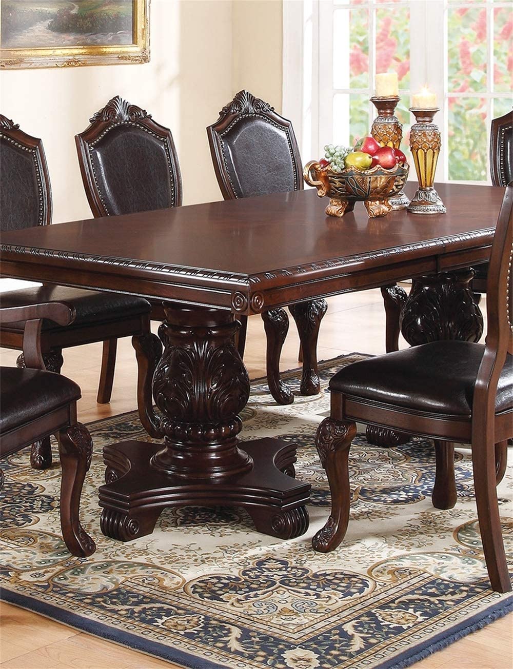 Ornate dark wood dining table with intricately carved pedestal base