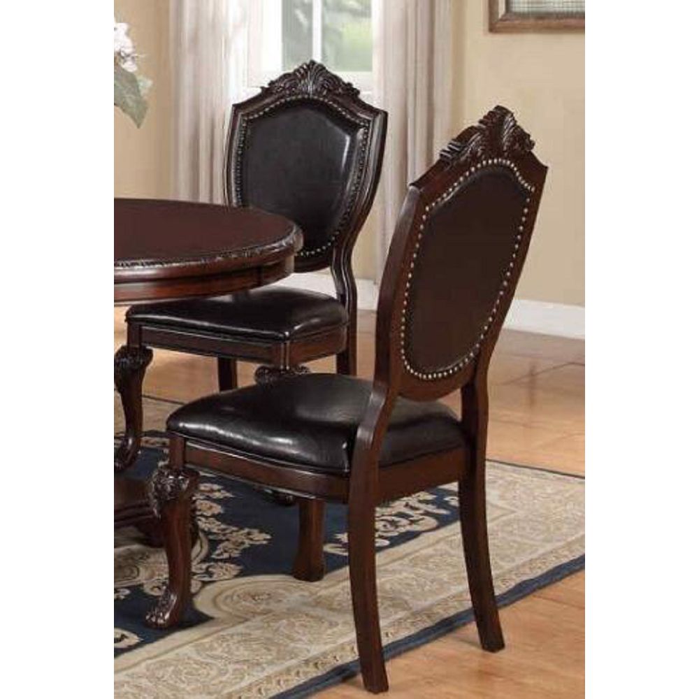 Dark mahogany dining chair with black leather seat and ornate carved legs