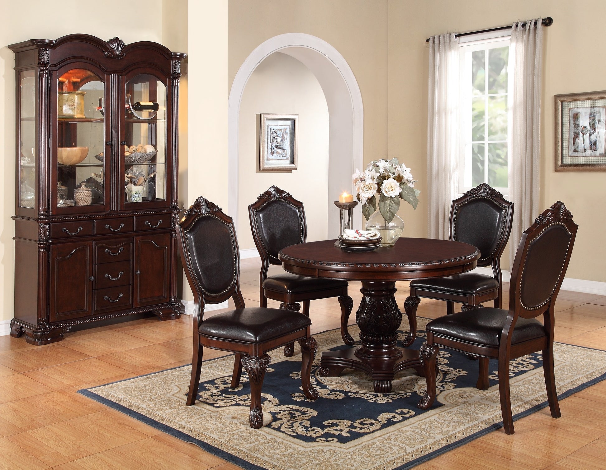 Ornate dark wood china cabinet with glass doors and display shelves showcasing dining essentials