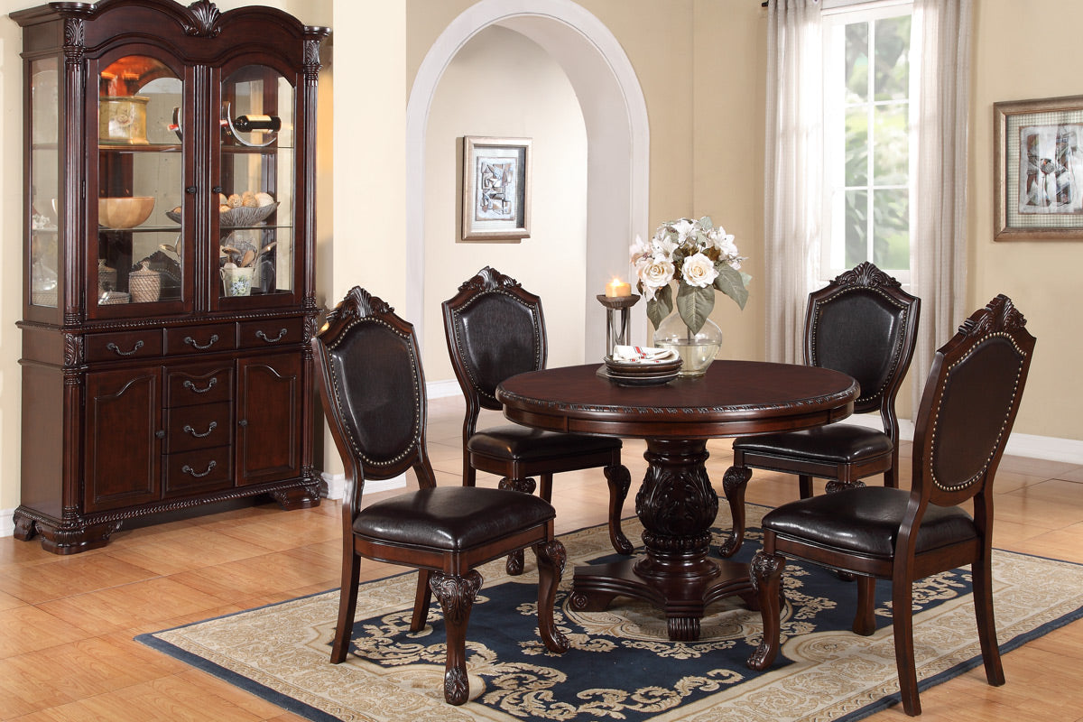 Ornate dark wood dining set with round table and four tufted leather chairs