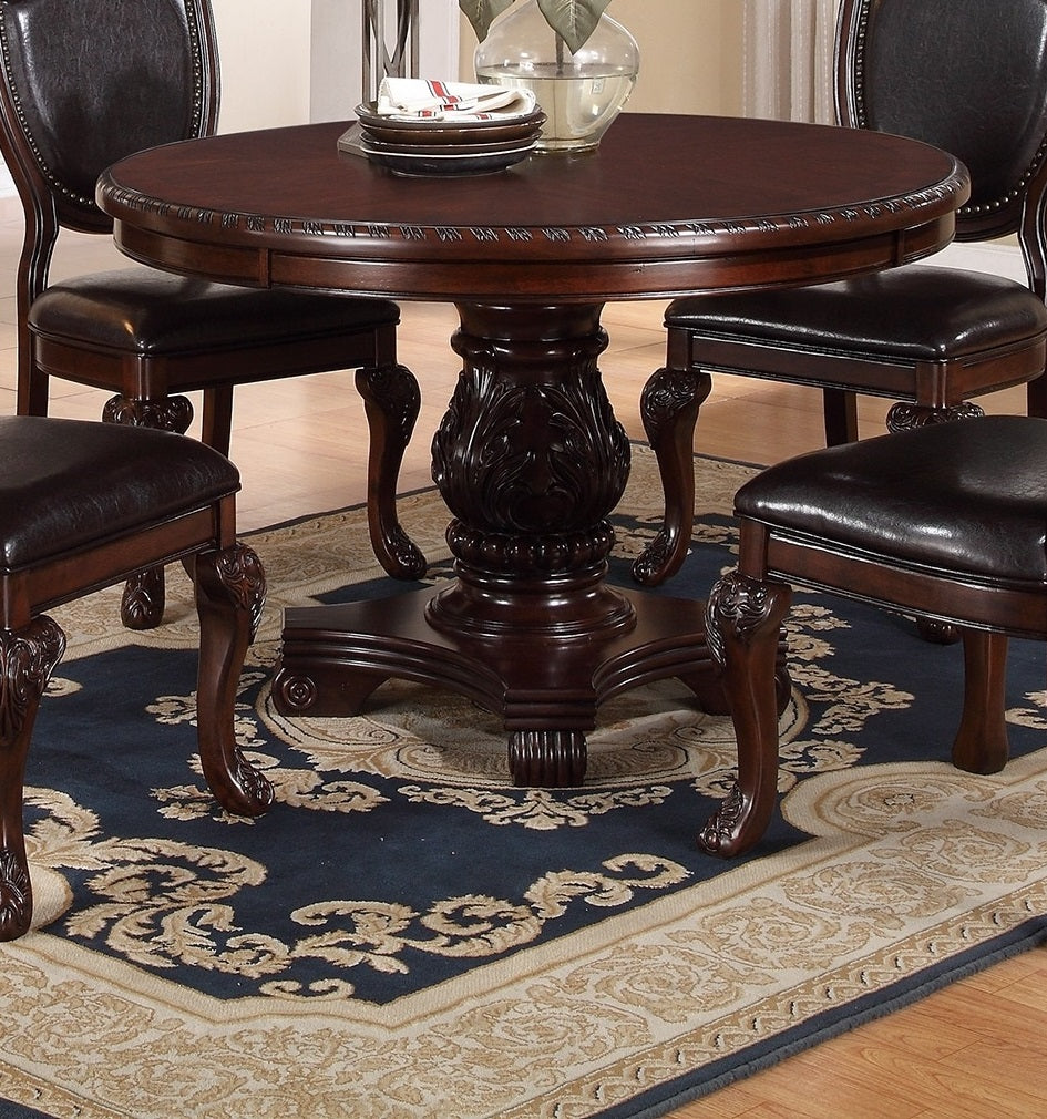 Ornate carved pedestal base on a dark wood round dining table