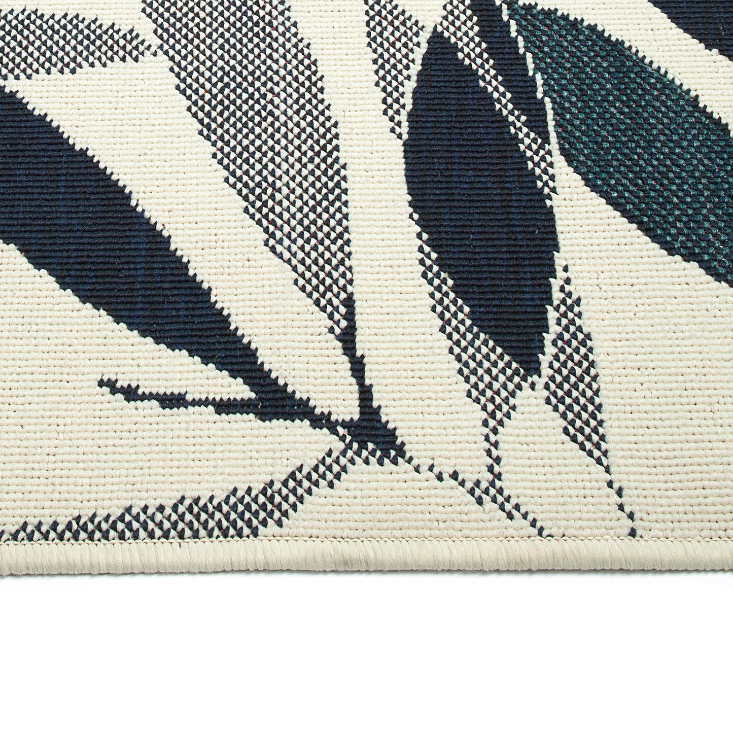 Textured cream rug with abstract navy and teal leaf pattern woven into fabric