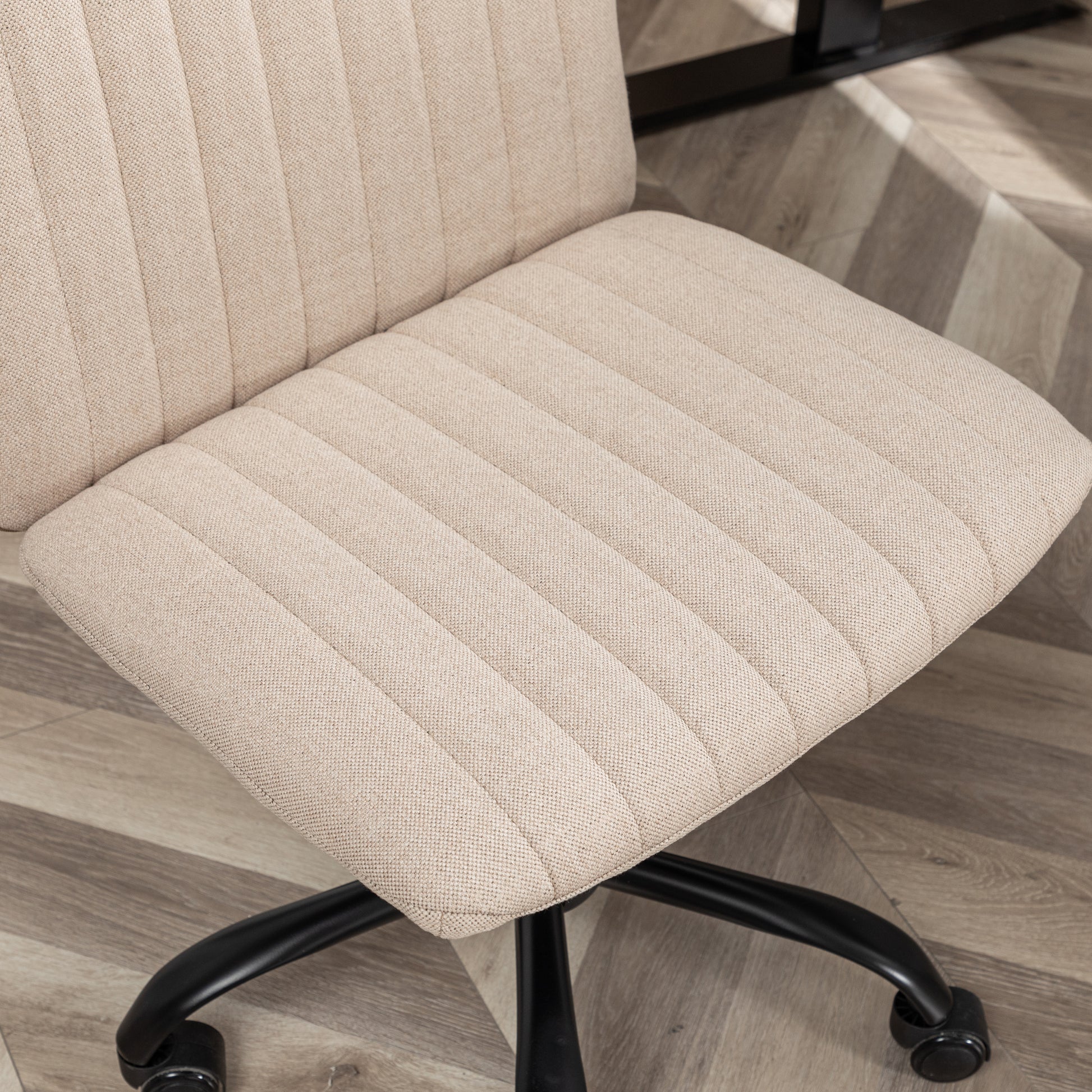 Beige upholstered office chair with padded seat and back black base and wheels