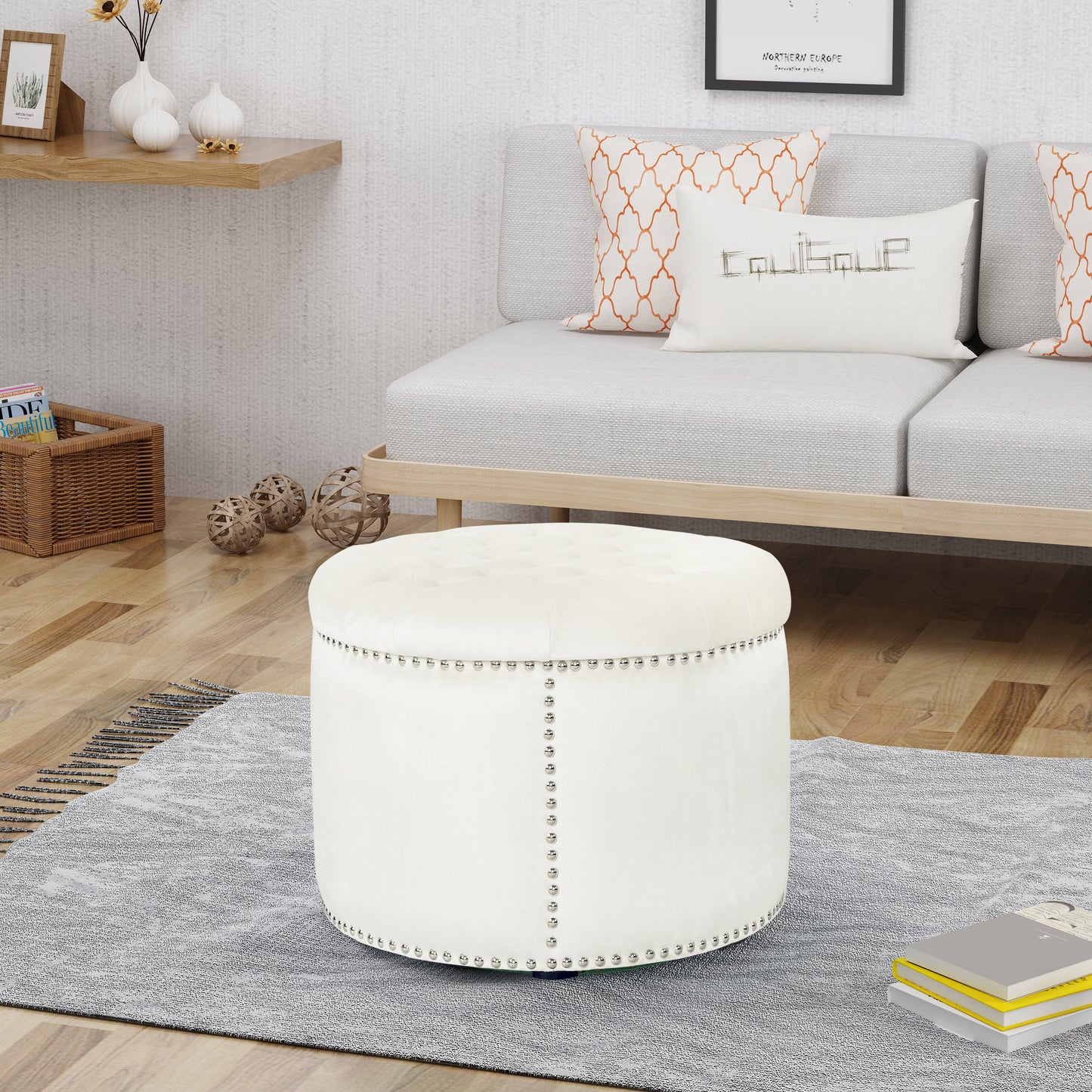 White velvet tufted ottoman with silver nailhead trim adding elegance to living spaces