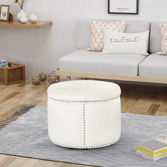 White velvet tufted ottoman with silver nailhead trim adding elegance to living spaces
