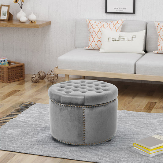 Grey velvet tufted storage ottoman with brass nailhead trim round shape